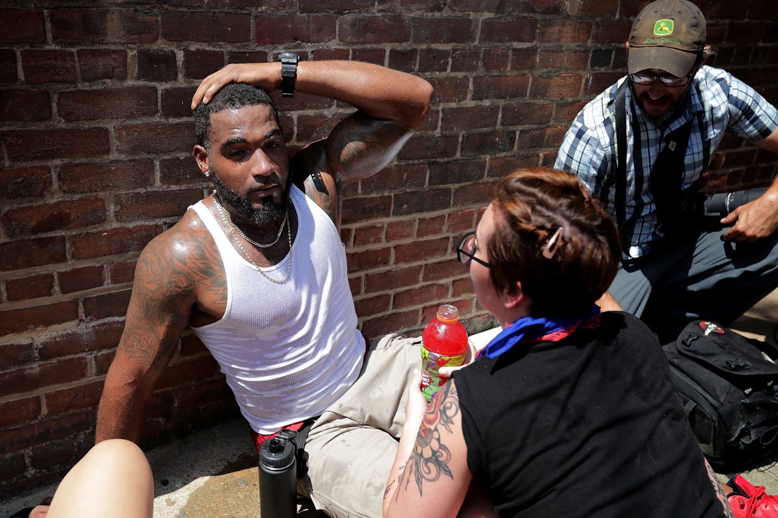 Rescue workers and volunteer medics tend to people who were injured when a car plowed through a crowd of counter-demonstrators marching through the downtown shopping district in Charlottesville, Va., on Aug. 12, 2017.