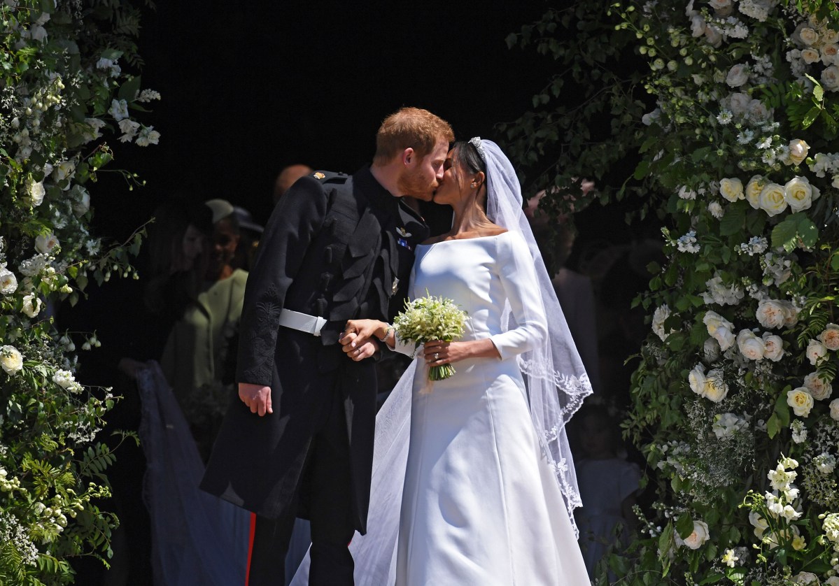 Prince Harry and Meghan Markle kiss as they exit St George's Chapel in Windsor Castle after their royal wedding ceremony, May 19, 2018.