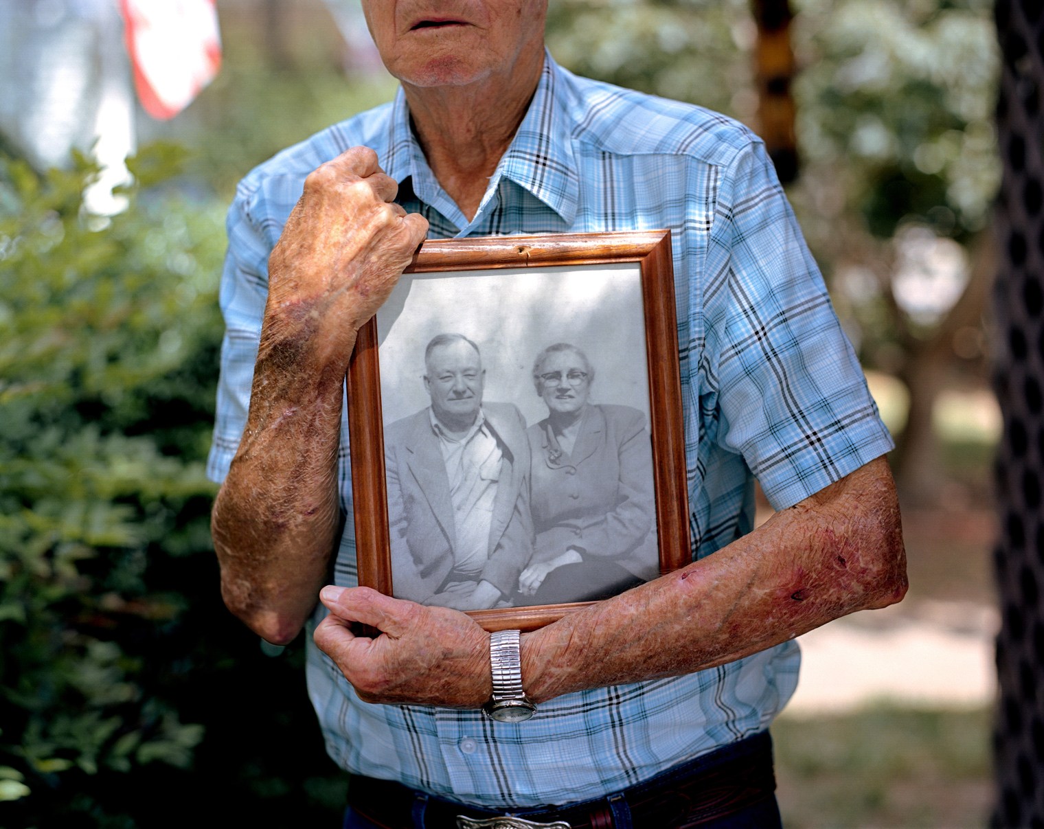 Gene Bowen holds a photograph of his parents at his home in LaGrange, Ga. Bowen was six years old when he awoke on a Sunday morning in 1940 to find his parents outside the home attending to a young African-American man, Austin Callaway, found bleeding to death on their property. The family wrapped the unconscious man in a bed sheet and rushed him to the local hospital, where he succumbed to his wounds. Callaway had been arrested the evening before. An armed group of hooded men snatched him from police custody without resistance, drove him to the edge of town, shot him multiple times and had left him to die.