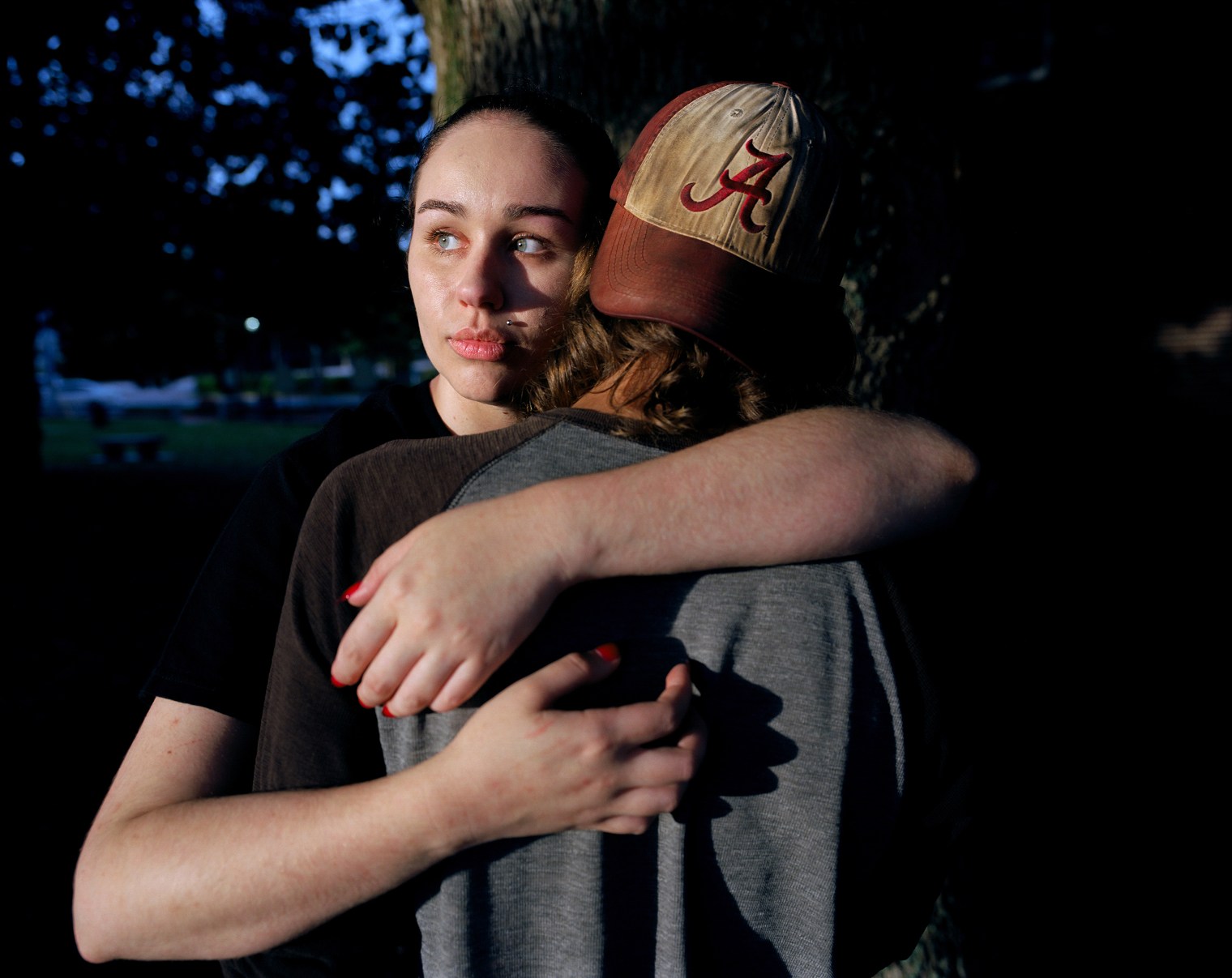 Two teenagers embrace in Lawrenceville, Ga. Every weekend, the community enjoys free movies at the downtown square, where in 1911 Charlie Hale was lynched in broad daylight. Few people today seem to remember the killing. In a souvenir photo postcard taken after Haleâ€™s death, crowds of white men, hound dogs and young boys surround the dead corpse; a sign attached to his toes reads, â€œPlease do not wake him.â€ In 1993, a local Sons of Confederate Veterans group erected a monument on the square to memorialize the Confederate dead; the inscription reads, â€œLest We Forget.â€