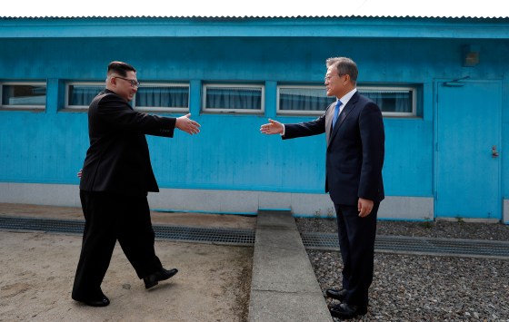 Kim, left, with Moon at the line dividing the two Koreas on April 27