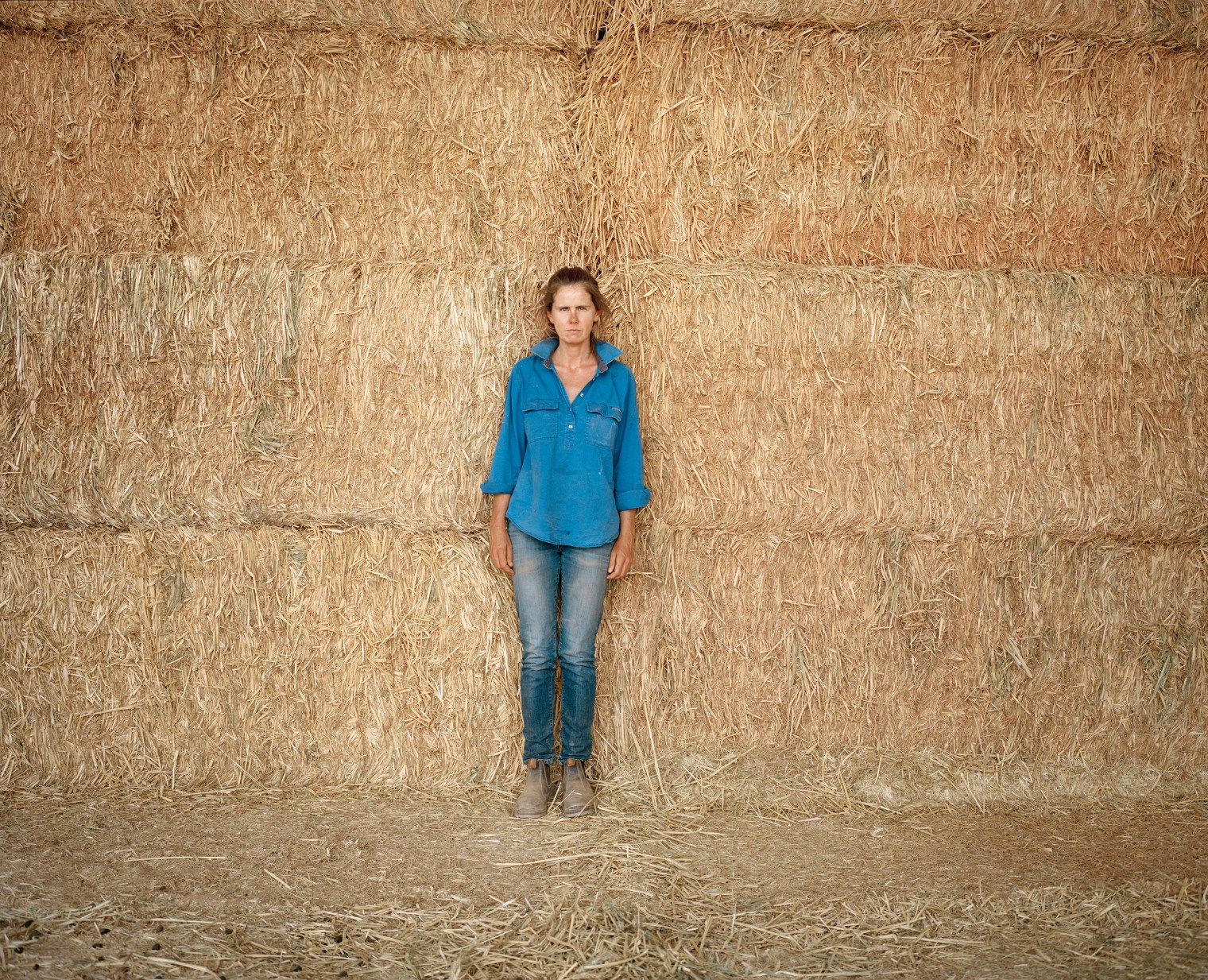 Jane Fehily, an Irish caretaker of Tongo Station, stands for a portrait at Paroo Pastoral Company's Yantabangee Station in New South Wales in December. The owner, Ray Dennis, supplements his farm income with a variety of off-farm businesses that have allowed him to endure the drought.