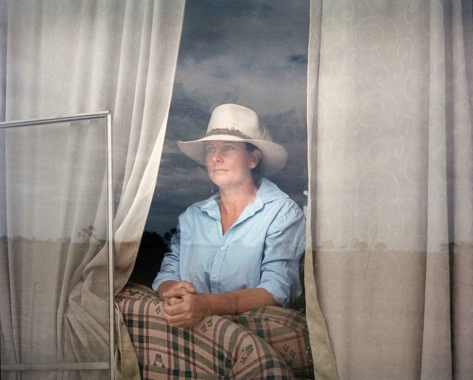 Krystal Bullen, 36, stands for a portrait at her home on Dunmore Property near Pilliga in November. Dunmore has been in her husband Gus's family for 111 years, and was inherited from his father. The drought has affected their business and caused Gus to seek off farm employment, working as a fencing contractor.