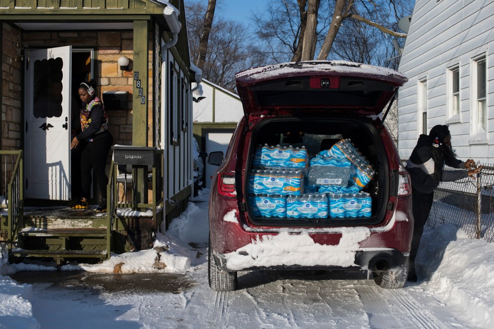 Flint residents ask Hawk for help getting safe water; sheâ€™s seen here in January with a friend delivering cases, which sheÂ bought.