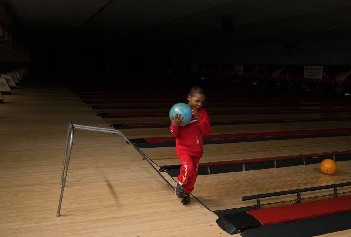 Sincere picks up his ball while bowling for his sixth birthday party at a bowling alley in Grand Blanc, Mich., on Monday, February 4, 2019.