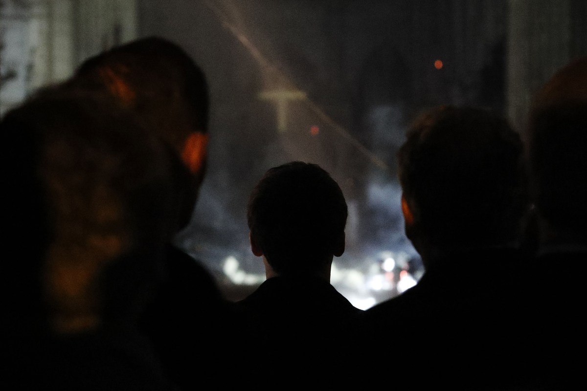 French President Emmanuel Macron looks inside the Notre-Dame Cathedral after a massive fire, April 15, 2019. 