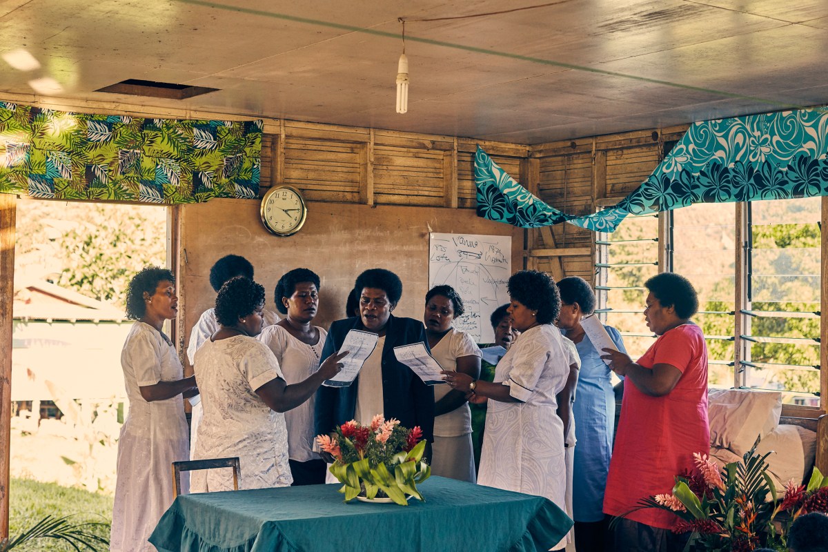 Villagers attend a church service on May 12 in the community center building.