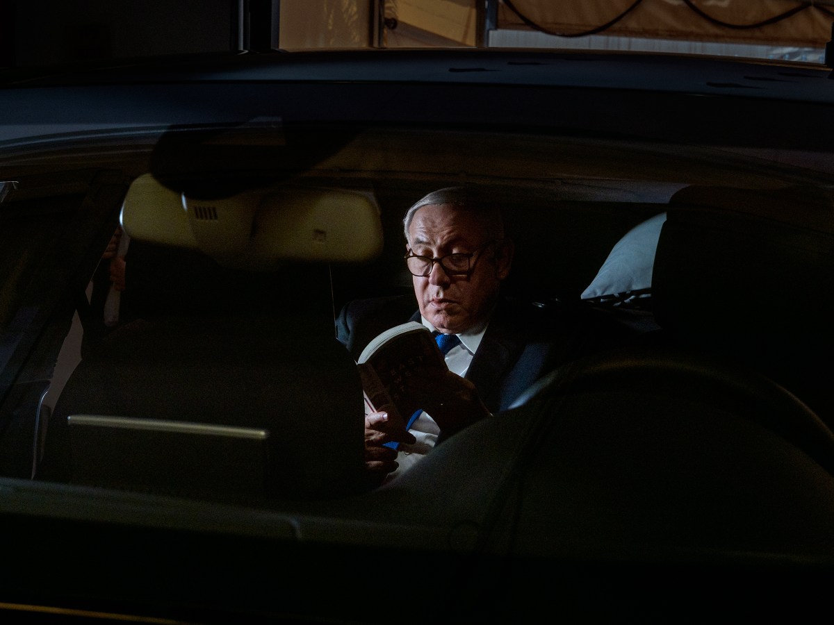 Netanyahu reads East West Street inside his car in Jerusalem on JuneÂ 25.