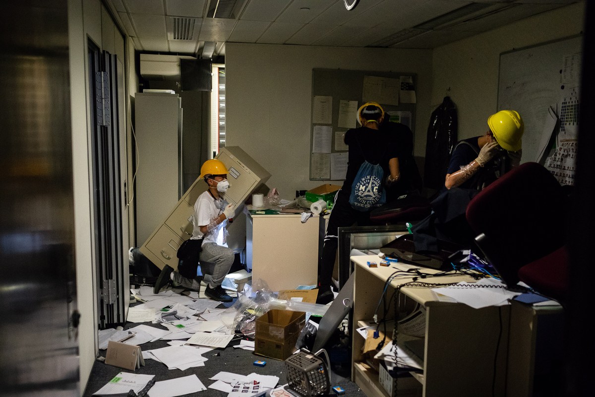 Demonstrators look through items in an office after breaking into the Legislative Council building during a protest in Hong Kong on July 1, 2019.