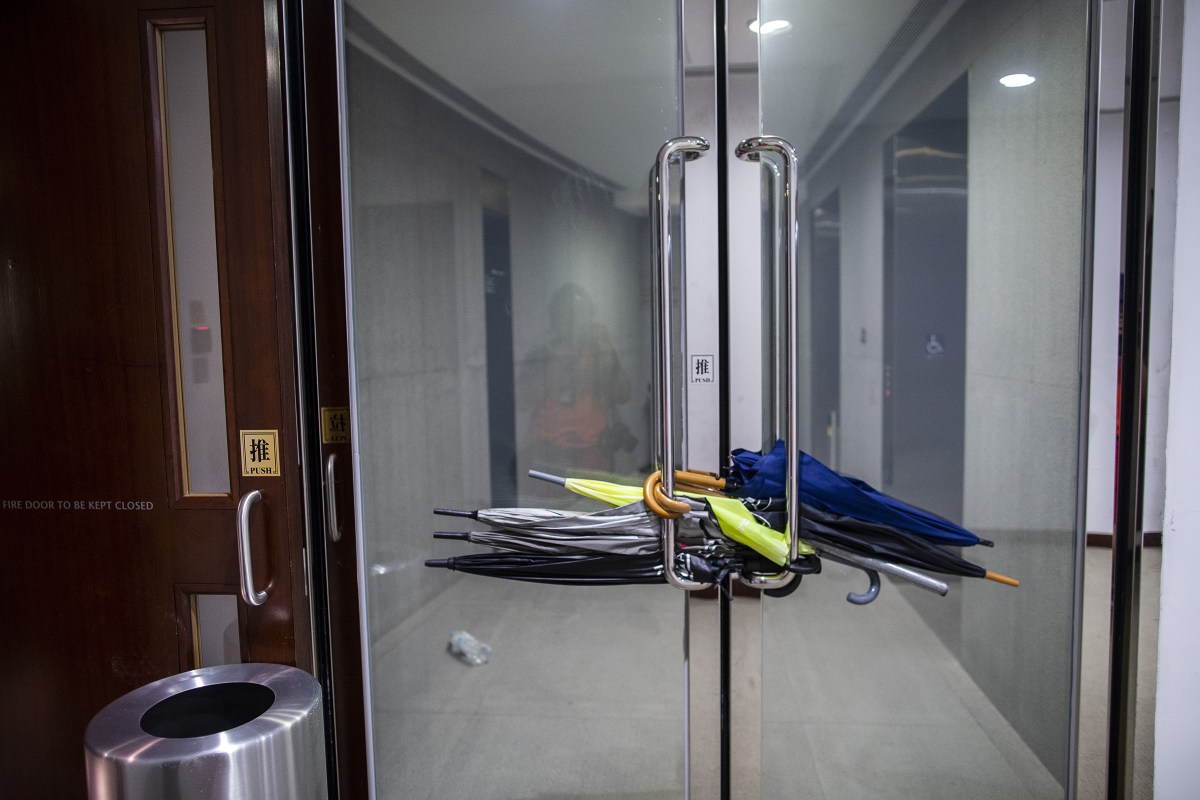 Umbrellas are used to block doors inside the Legislative Council building in Hong Kong on July 1, 2019.