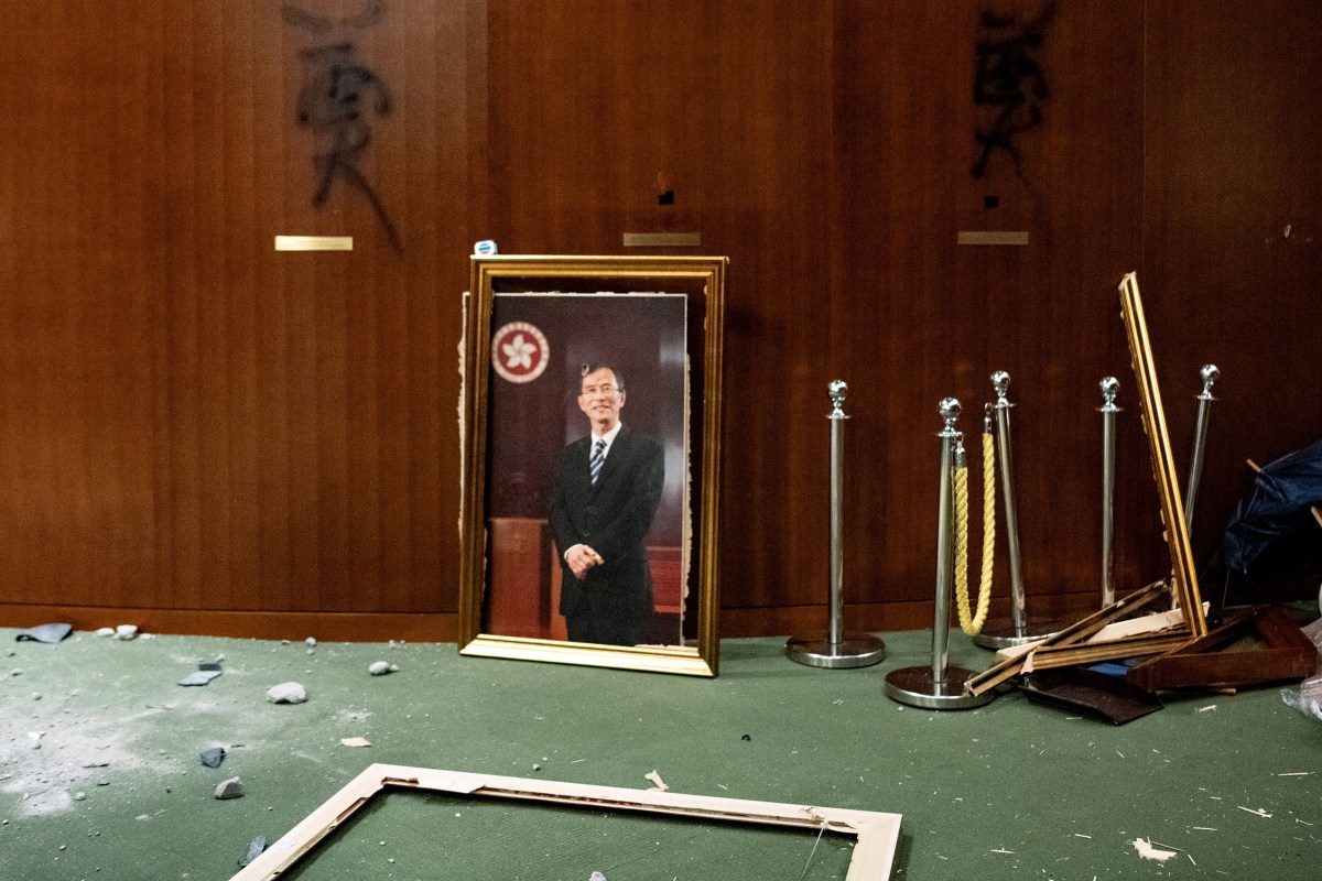 The portrait of former chairman of the Legislative Council Jasper Tsang is destroyed after protesters broke into the chamber of the Legislative Council in Hong Kong on July 1, 2019.