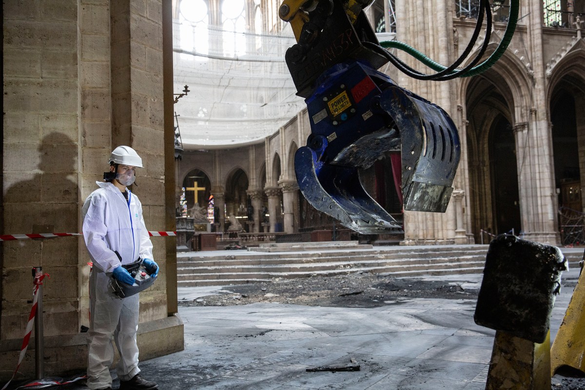 A technician clears rubble inside the cathedral on JulyÃŠ11.