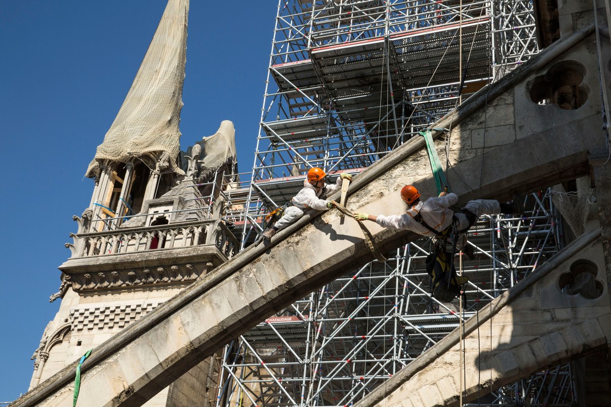 Workers prepare the Cathedral's flying buttresses, where wooden arches will be installed to support the structure.