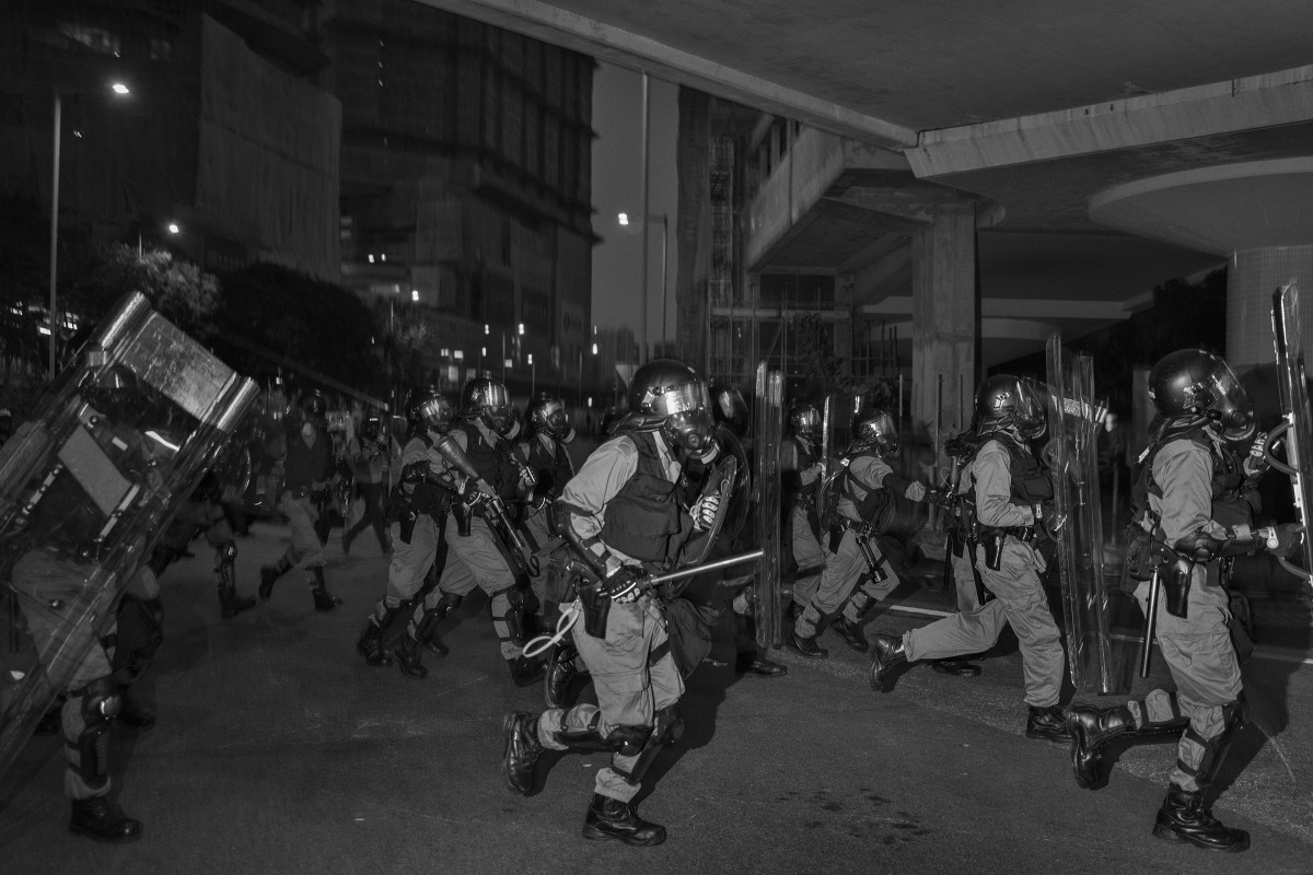 Riot police clear an unauthorized antigovernment protest near the Tai Wai train station on Aug. 10.