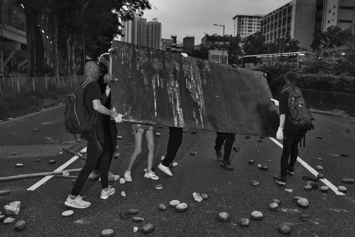 Antigovernment protesters block a road near the Tai Wai train station on Aug. 10.