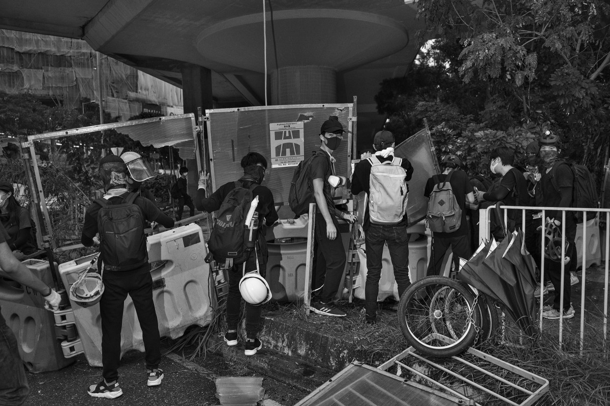 Antigovernment protesters block a road near the Tai Wai train station on Aug. 10.