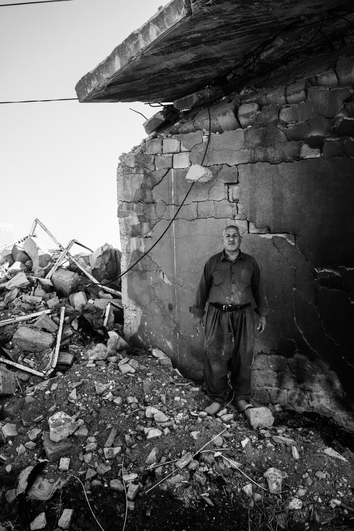 Mohsin Hairan Aswad, 60, a wealthy Yazidi Kurd from Bashiqa, stands in the remains of one of the seven homes that he owns. His homes were destroyed during the fighting to liberate the town from ISIS control in 2016. The next year, his son Faris, a local policeman in Mosul, was killed by an ISIS sniper.