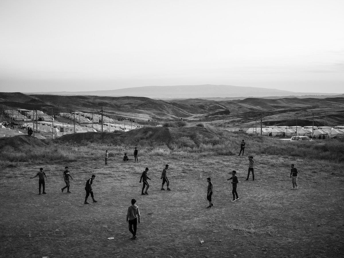 Refugees play soccer inside the Bardarash camp, which had hosted Iraqis displaced by the offensive against ISIS in Mosul and reopened in October to accommodate Kurds fleeing the Turkish offensive in Syria.